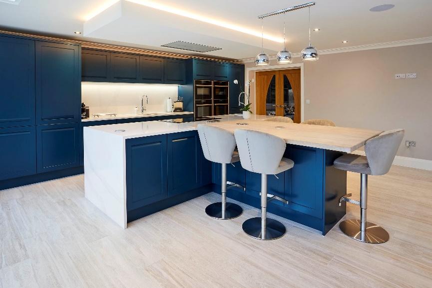 A kitchen with blue cabinets and white countertops

Description automatically generated