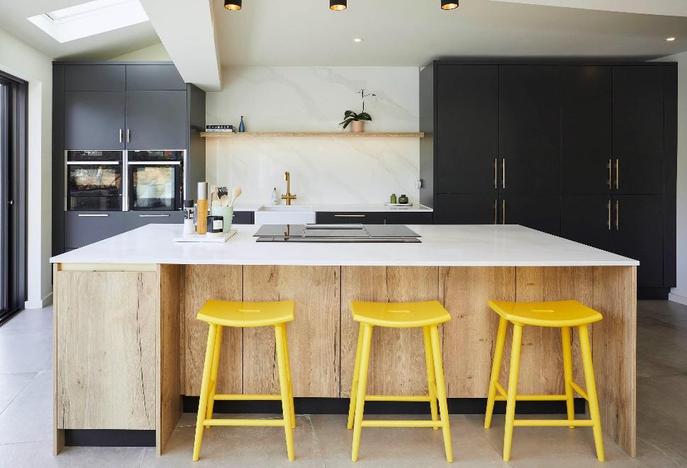 A kitchen with yellow stools

Description automatically generated
