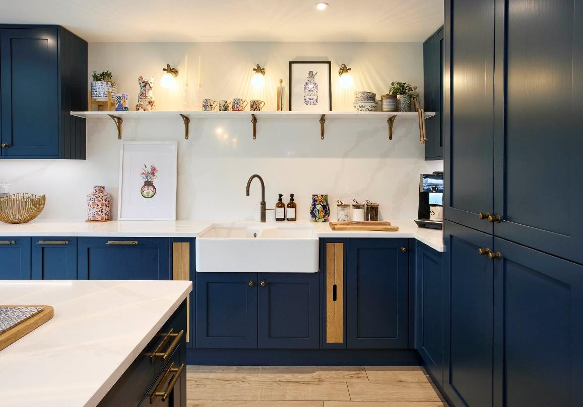 A kitchen with blue cabinets and shelves

Description automatically generated