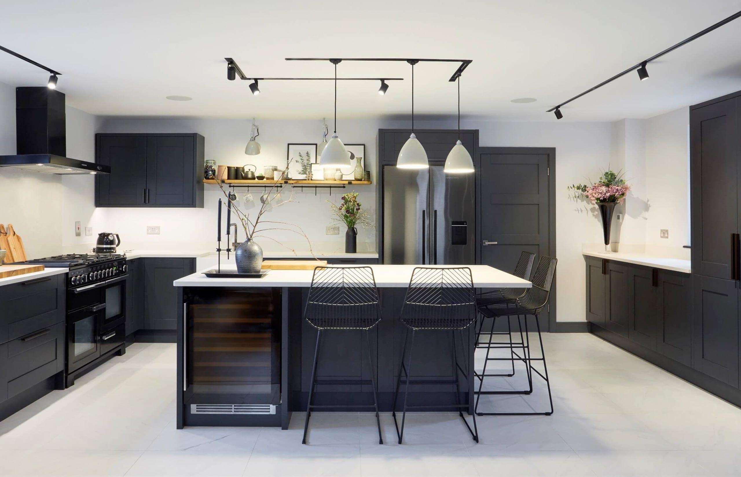 British Racing Green kitchen with shaker-style cabinets, quartz worktops, and brushed bronze hardware - Ashford Kitchens and Interors